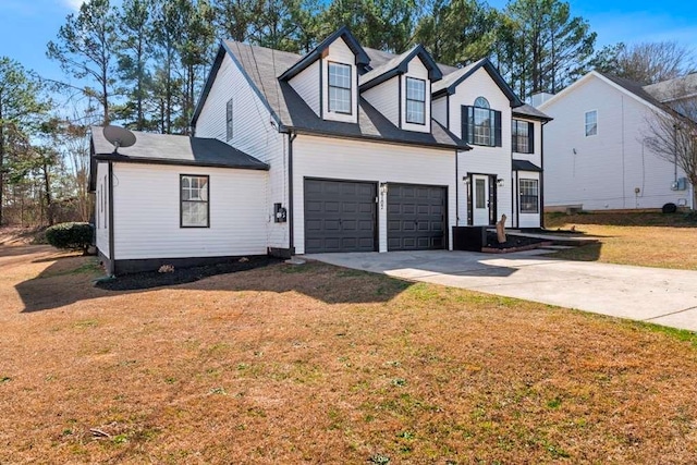 view of front of home with a garage, concrete driveway, and a front yard