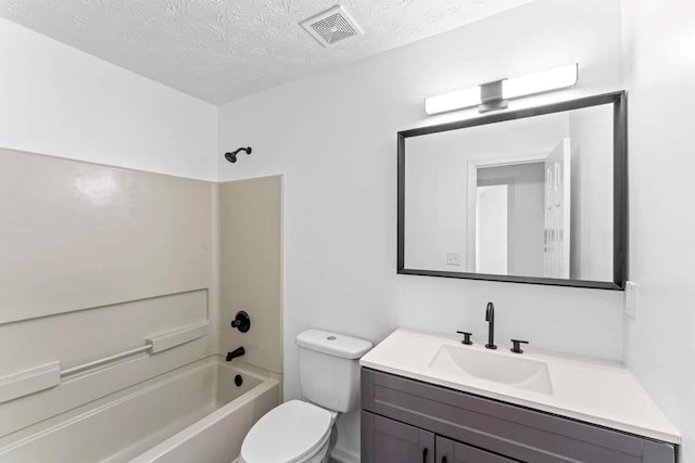 bathroom featuring vanity, visible vents, bathtub / shower combination, a textured ceiling, and toilet