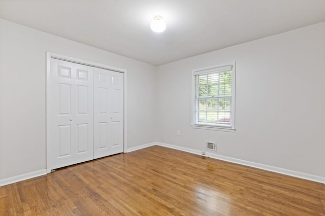 256 Teresa Ln, Loganville, GA 30052 - unfurnished bedroom with wood finished floors, baseboards, and a closet