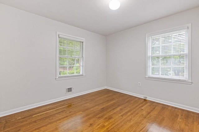 256 Teresa Ln, Loganville, GA 30052 - unfurnished room with healthy amount of natural light, baseboards, and wood finished floors