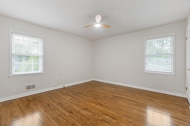 256 Teresa Ln, Loganville, GA 30052 - spare room featuring healthy amount of natural light, wood finished floors, a ceiling fan, and baseboards