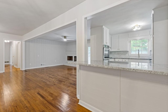 256 Teresa Ln, Loganville, GA 30052 - kitchen with oven, dark wood-style floors, a ceiling fan, and a sink