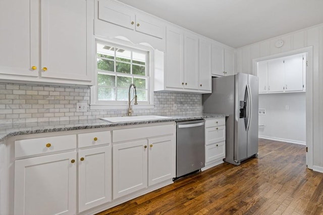 256 Teresa Ln, Loganville, GA 30052 - kitchen with stainless steel appliances, a sink, white cabinetry, tasteful backsplash, and dark wood-style flooring