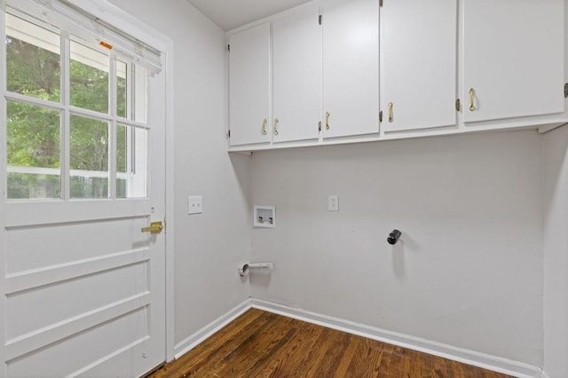 256 Teresa Ln, Loganville, GA 30052 - laundry area with cabinet space, baseboards, dark wood-style floors, and washer hookup