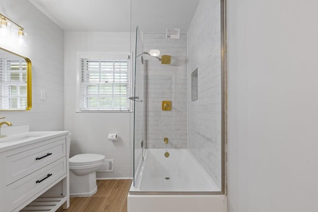 256 Teresa Ln, Loganville, GA 30052 - bathroom featuring toilet, combined bath / shower with glass door, vanity, and wood finished floors