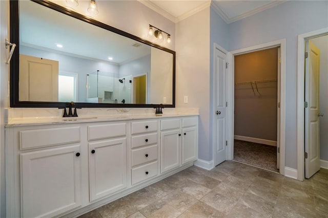 bathroom with vanity, ornamental molding, and a shower with shower door