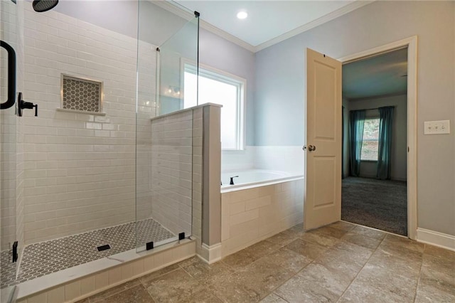 bathroom featuring independent shower and bath, a wealth of natural light, and ornamental molding