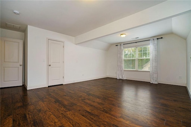 bonus room with vaulted ceiling with beams and dark hardwood / wood-style floors