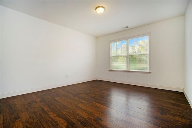 empty room with dark hardwood / wood-style floors