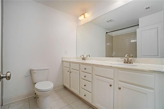 bathroom featuring vanity, toilet, tile patterned floors, and a tile shower