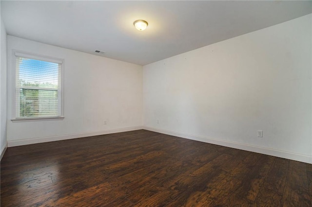 unfurnished room with dark hardwood / wood-style floors