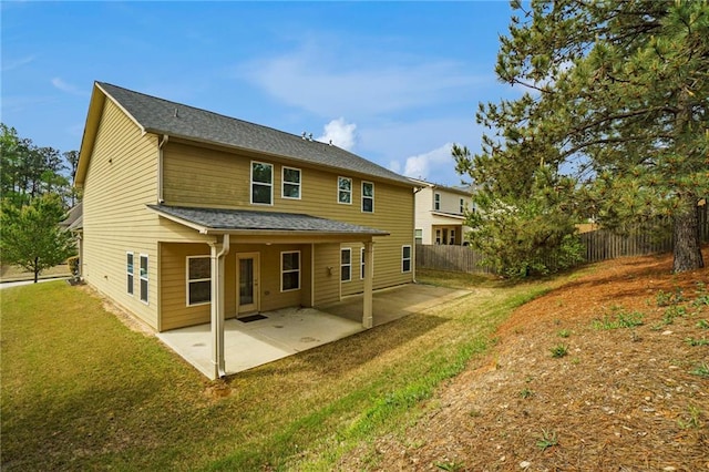 back of property with a yard and a patio area