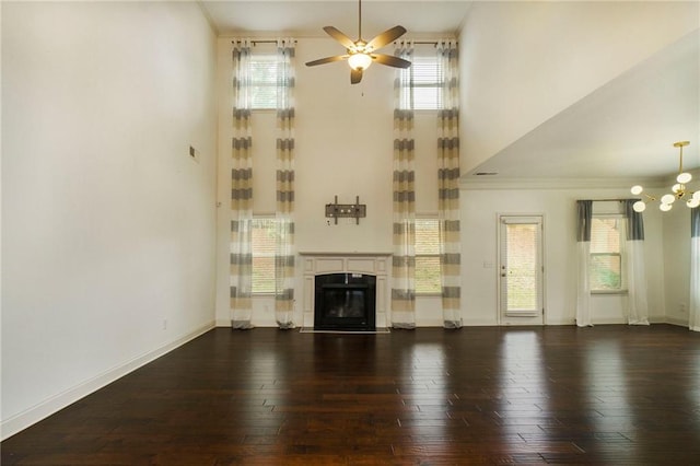 unfurnished living room featuring crown molding, dark hardwood / wood-style floors, and ceiling fan