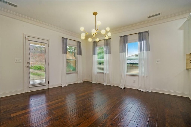 spare room featuring crown molding, dark wood-type flooring, a chandelier, and plenty of natural light