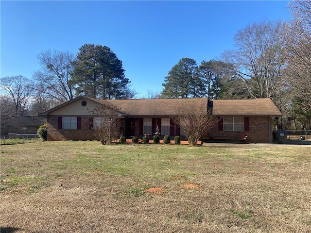 single story home with a front lawn and brick siding