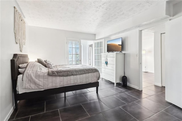 tiled bedroom featuring a textured ceiling