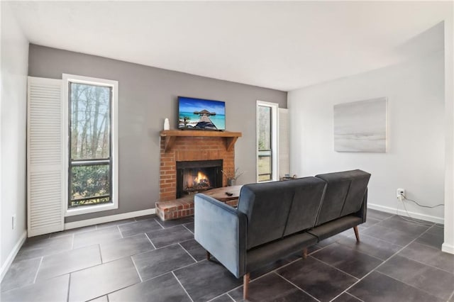 tiled living room featuring a brick fireplace