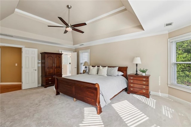 bedroom with a raised ceiling, baseboards, light colored carpet, and visible vents