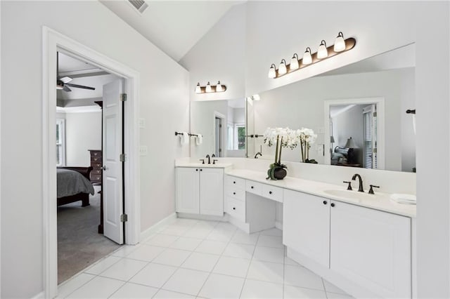 ensuite bathroom with visible vents, double vanity, connected bathroom, a sink, and vaulted ceiling