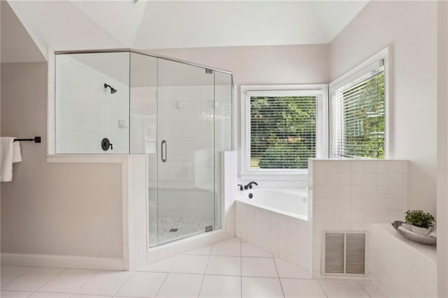 bathroom featuring tile patterned flooring, a shower stall, a bath, and visible vents