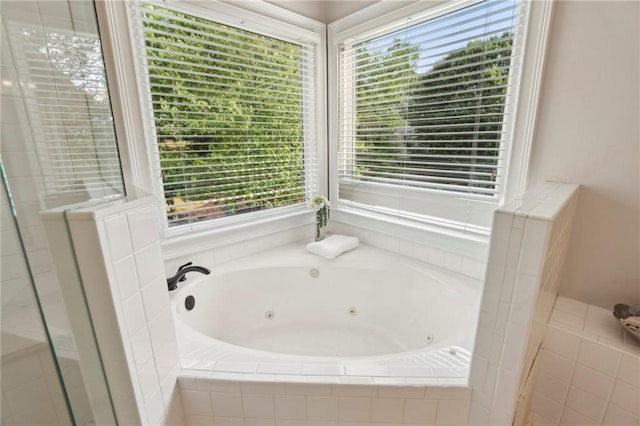 full bathroom featuring plenty of natural light and a jetted tub