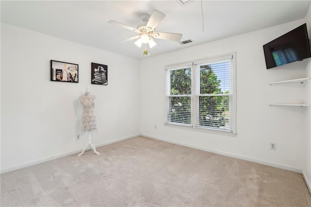 carpeted empty room with visible vents, attic access, and baseboards