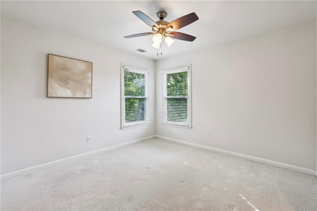 unfurnished room with carpet floors, baseboards, and visible vents