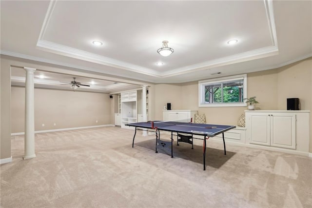 game room with light colored carpet, a raised ceiling, decorative columns, and ornamental molding