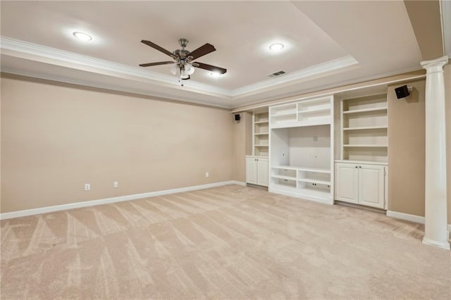 interior space with visible vents, crown molding, a raised ceiling, baseboards, and ornate columns
