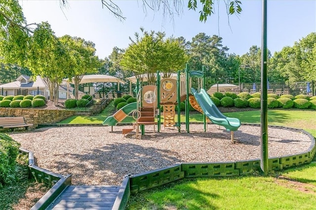 community playground with fence and a lawn