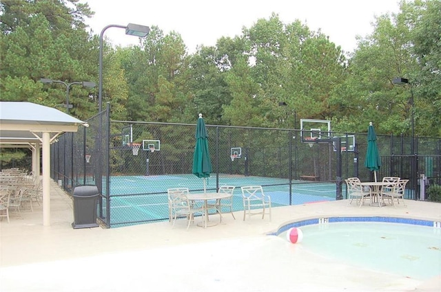 view of sport court featuring fence and community basketball court