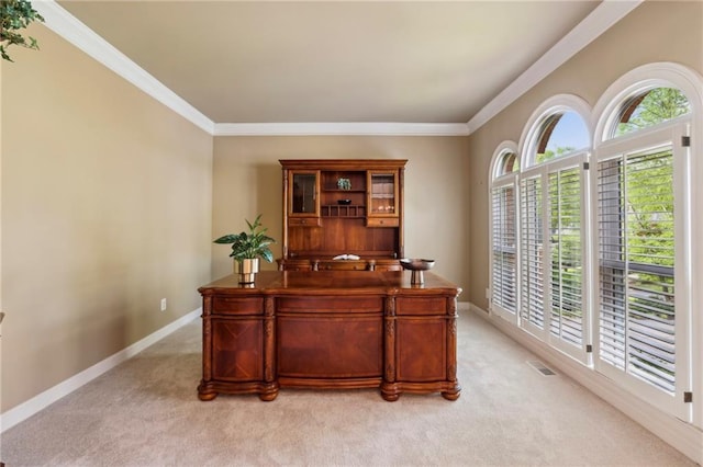 home office with crown molding, baseboards, light colored carpet, and visible vents