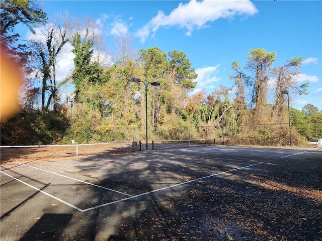 view of sport court featuring fence