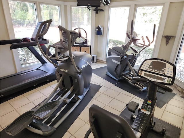 gym featuring a healthy amount of sunlight and light tile patterned floors