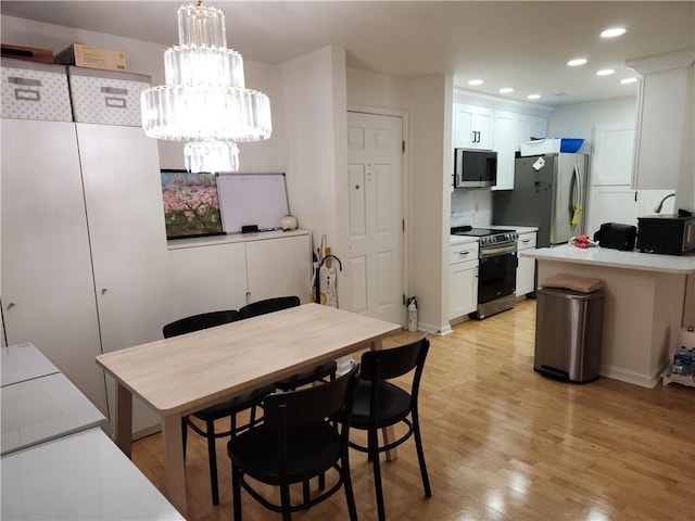 dining space with light wood-type flooring and recessed lighting