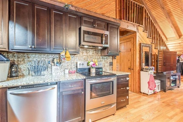 kitchen featuring decorative backsplash, light wood-type flooring, appliances with stainless steel finishes, light stone counters, and dark brown cabinetry