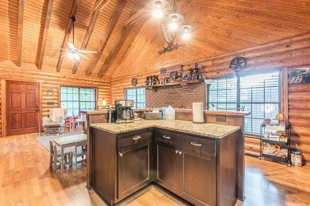 kitchen with rustic walls, wood ceiling, dark brown cabinets, beam ceiling, and light hardwood / wood-style flooring