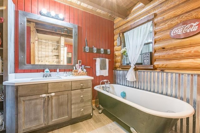 bathroom with rustic walls, vanity, a bath, beam ceiling, and wooden ceiling