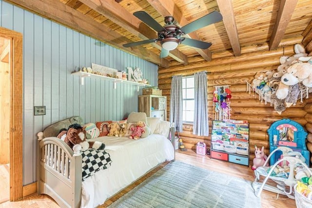 bedroom featuring rustic walls, ceiling fan, beam ceiling, light hardwood / wood-style flooring, and wooden ceiling