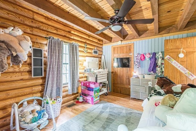 bedroom with rustic walls, wood ceiling, ceiling fan, beam ceiling, and light hardwood / wood-style flooring