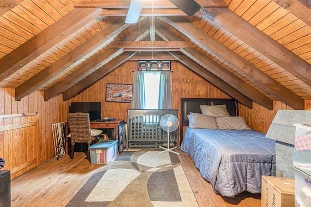 bedroom with vaulted ceiling with beams, wood walls, wood-type flooring, and wooden ceiling