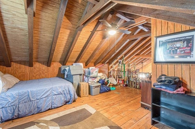 bedroom with wooden walls, wooden ceiling, lofted ceiling with beams, and hardwood / wood-style flooring