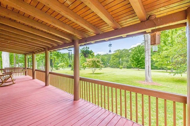 wooden deck featuring a lawn