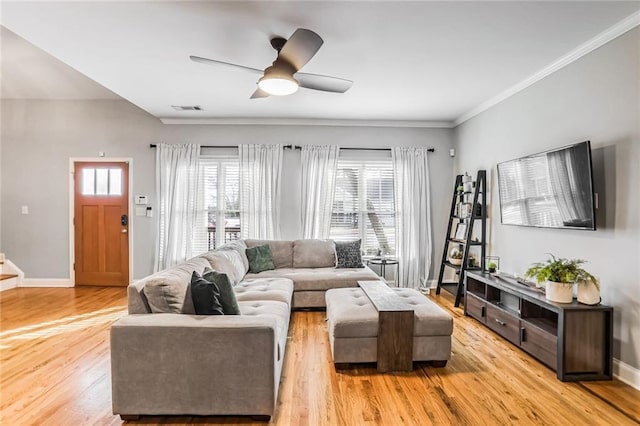 living room featuring crown molding, light hardwood / wood-style floors, and ceiling fan