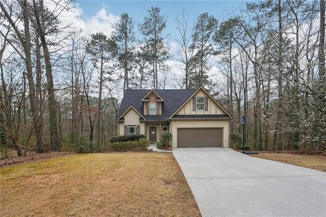 craftsman-style house featuring a garage, driveway, and a front yard