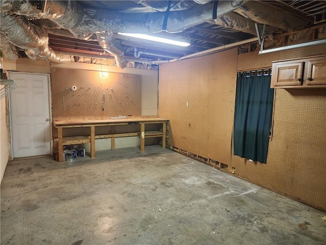 unfinished basement with a workshop area