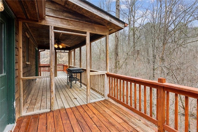 wooden terrace featuring ceiling fan