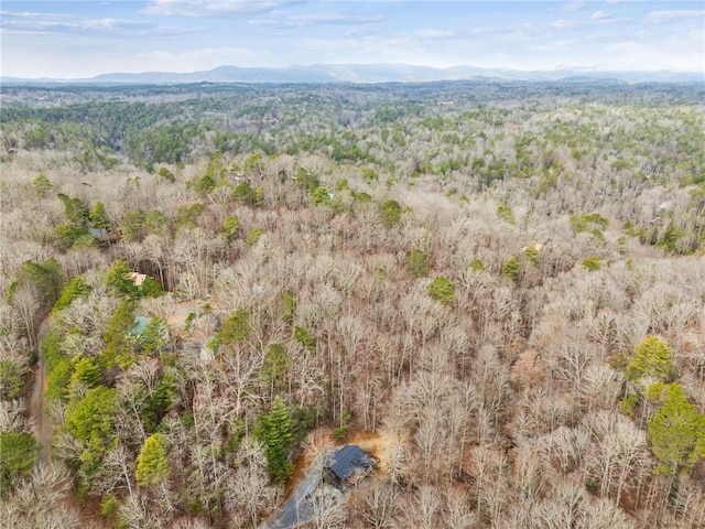 aerial view with a wooded view and a mountain view