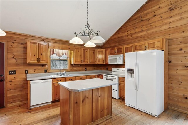 kitchen with lofted ceiling, sink, hanging light fixtures, dishwasher, and light hardwood / wood-style floors