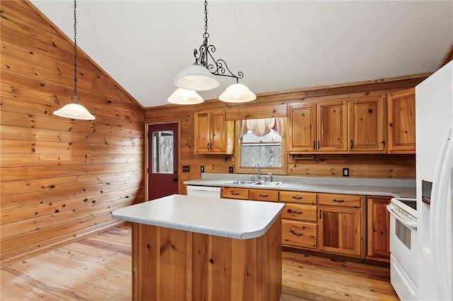 kitchen with light wood finished floors, lofted ceiling, light countertops, a sink, and white appliances